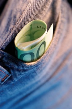 Close-up of a roll of Euro banknotes in a pocket