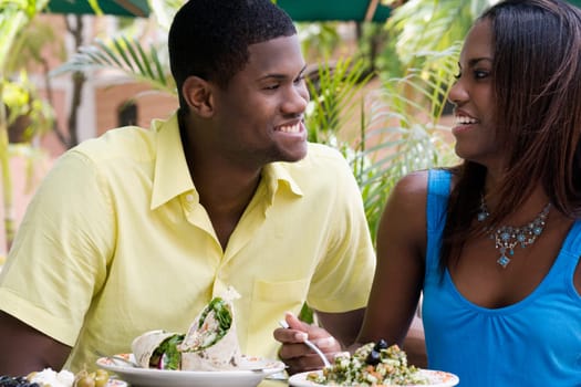 Close-up of a young man and a teenage girl sitting in a restaurant