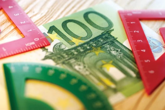 Close-up of geometric instruments on a one hundred Euro banknote