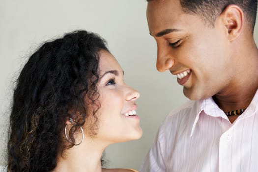 Close-up of a young couple looking at each other and smiling