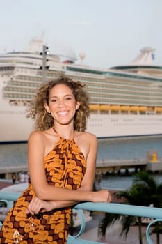 Portrait of a teenage girl leaning against a railing and smiling