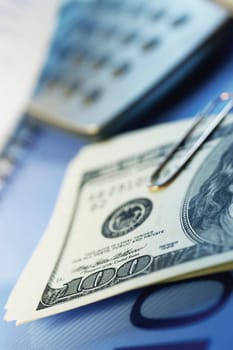 Paper clips, United States one hundred dollar bills, calculator