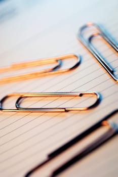 Paper clips and lined paper, close-up