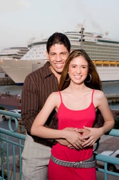 Portrait of a young man embracing a teenage girl from behind