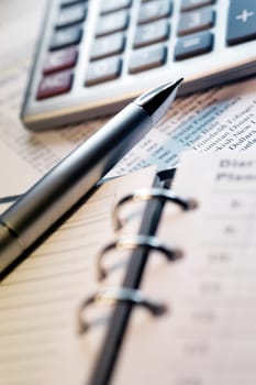 Appointment book, calculator and pen, close-up