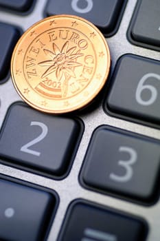 Close-up of Eurocent coin on calculator