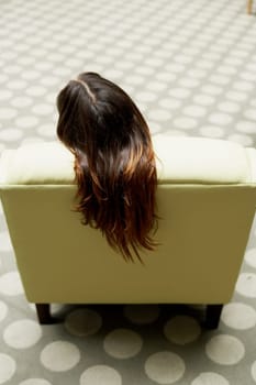 High angle view of a woman sitting on a chair
