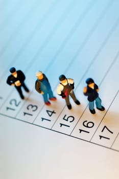 Appointment book with toy men standing on it