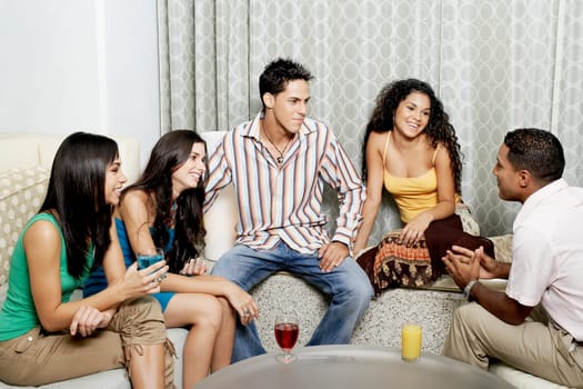 Group of friends talking to each other and smiling