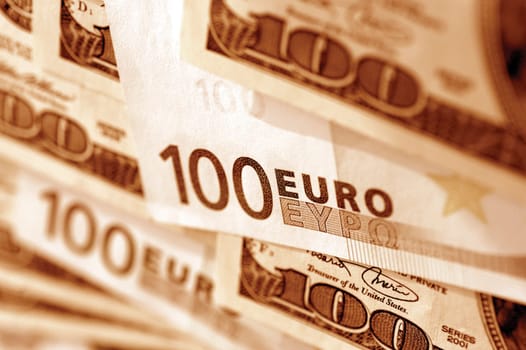 Euro 100 bank notes and United States one hundred dollar bills, close-up