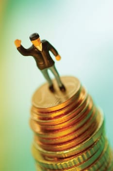 Toy man on top of stack of coins