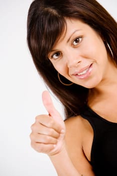 Portrait of a young woman making Thumbs Up sign and smiling