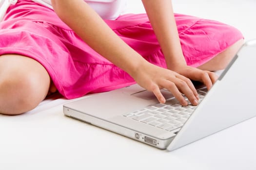 Mid section view of a woman using a laptop