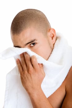 Portrait of a young man wiping his face with a towel