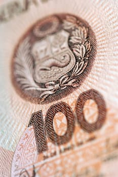 Extreme close-up of symbol and number 100 on bank note