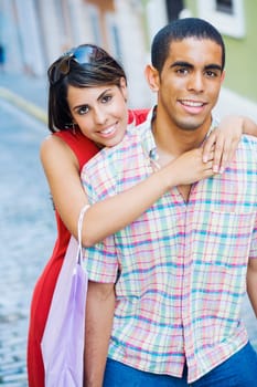 Portrait of a teenage girl embracing a young man from behind