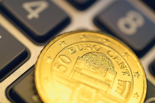 Close-up of Eurocent coin on calculator