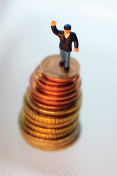 Toy man on top of stack of coins