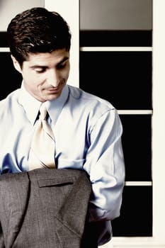 Close-up of a businessman holding his coat