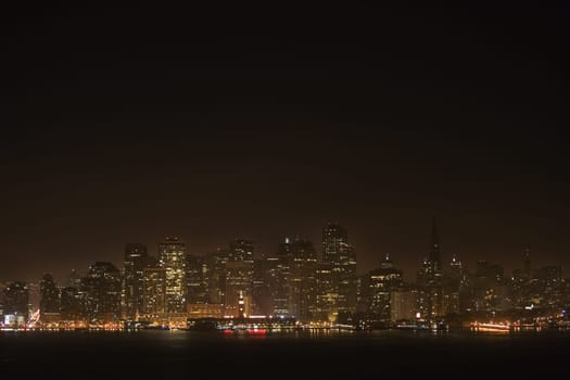 Illuminated buildings at waterfront, California, USA