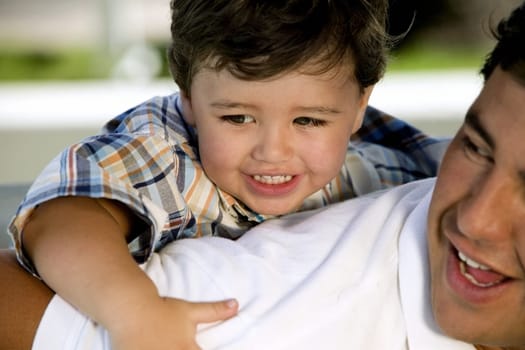 Close-up of a boy riding piggyback on his father