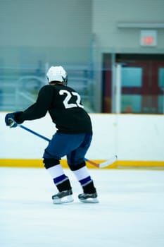 Rear view of an ice hockey player playing ice hockey
