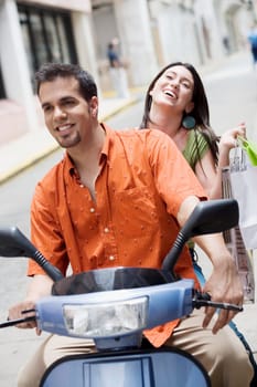 Close-up of a mid adult man and a teenage girl riding a scooter