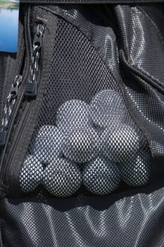 Close-up of golf balls in a golf bag