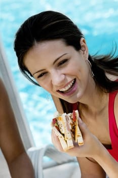 Close-up of a young woman holding a sandwich