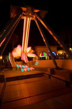 Lights glowing on a carnival ride at night, California, USA