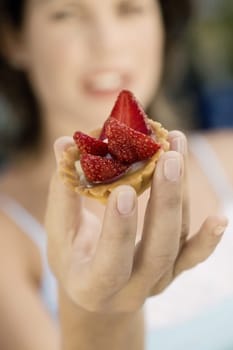 Young woman holding a cupcake