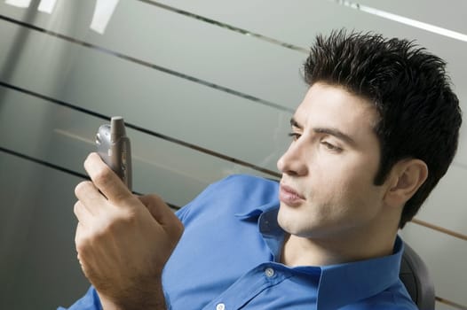 Close-up of a young man holding a mobile phone