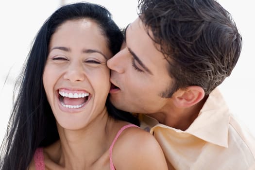 Close-up of a young man kissing a young woman