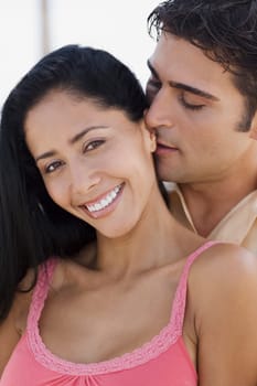 Close-up of a young man embracing a young woman from behind