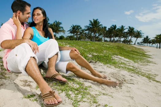 Close-up of a young couple smiling on the beach