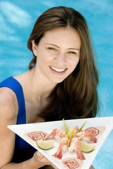Portrait of a young woman holding a tray