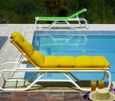 Empty chairs at the poolside