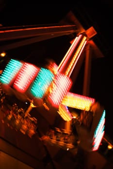 Lights glowing on a carnival ride at night, California, USA