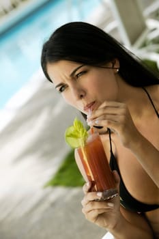 Close-up of a young woman sipping drink from a glass