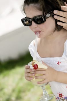 Close-up of a girl sipping drink from a glass