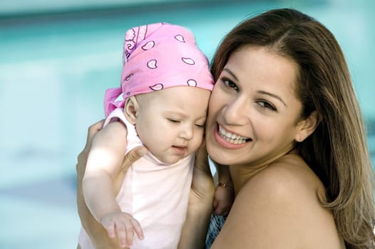 Portrait of a young woman holding her daughter