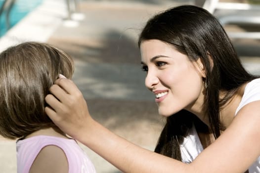 Close-up of a mother with her daughter smiling