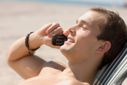 Side profile of a young man talking on a mobile phone