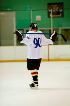 Rear view of an ice hockey player holding an ice hockey stick