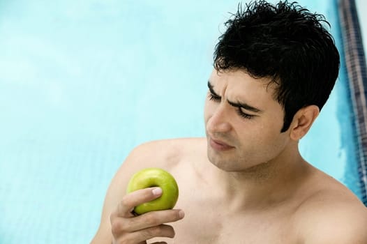 High angle view of a young man holding an apple