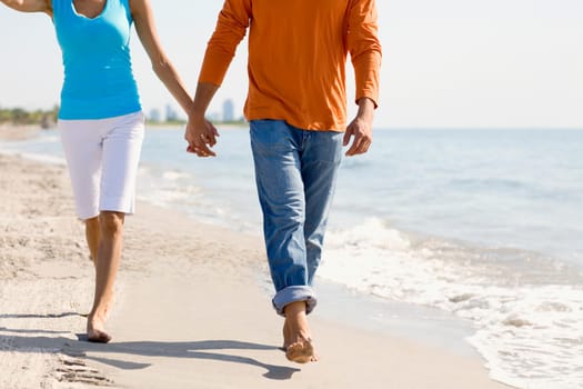 Close-up of a young couple walking on the beach