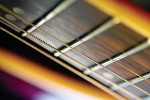Extreme close-up of guitar frets and strings