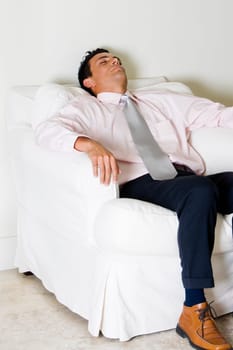 Businessman sleeping in an armchair