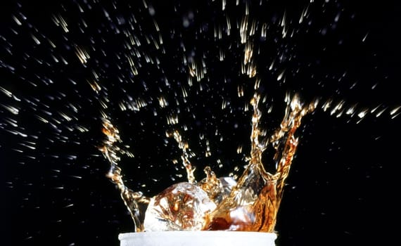 Close-up of water splashing out of a glass