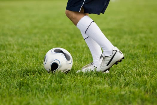 Low section view of a soccer player with a soccer ball